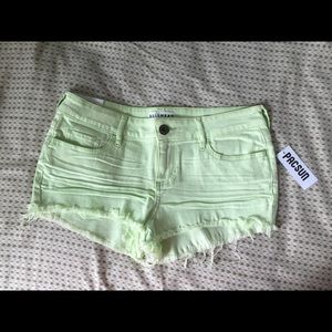 Light green frayed shorts