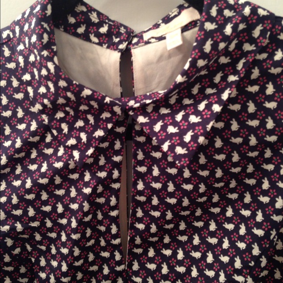 Sleeveless navy dress with collared neck.