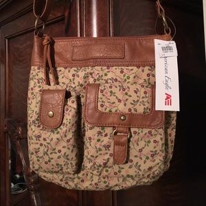 Floral and leather like purse with pockets.