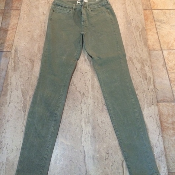 Distressed green jeans