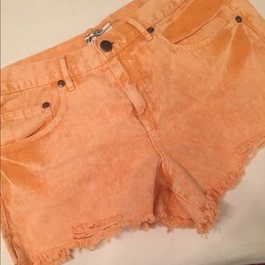 Free People distressed orange cut off jean shorts