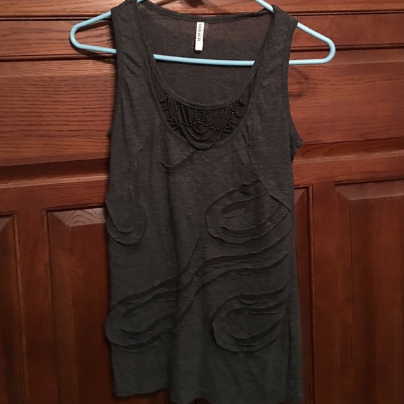 Sleeveless tank with decorative design.