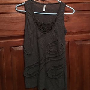 Sleeveless tank with decorative design.