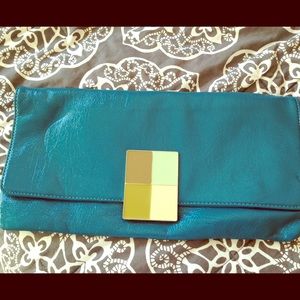 Bright teal clutch with multi color buckle