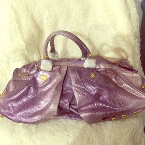 Purple purse with gold embellishments