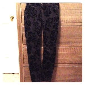 Black skinny jeans with velvet roses pattern.