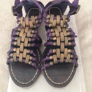 Purple and bronze flat sandals.