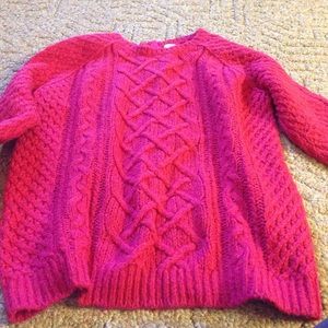 Women's pink cable knit sweater.
