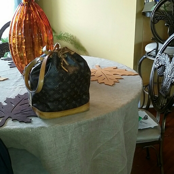 Louis Vuitton...aged signs around bottom of bag