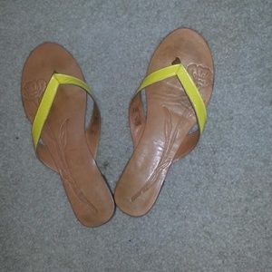 Yellow strapped flip flops