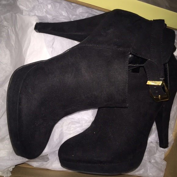 Black suede booties. Strapped at the ankle