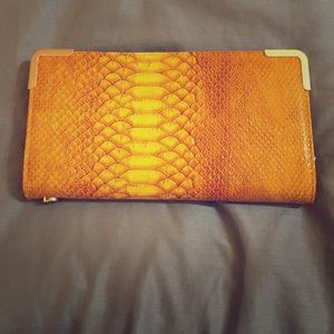 Gold snake skin clutch