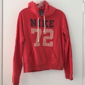 coral colored Nike sweatshirt
