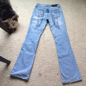 Sinful jeans with angel wing design.