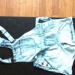 Blue jean short overalls.