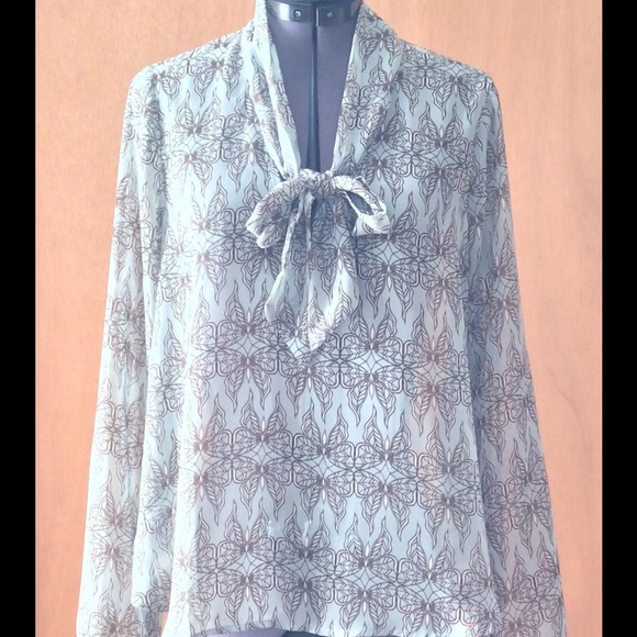 Butterfly blouse with keyhole opening and tie.