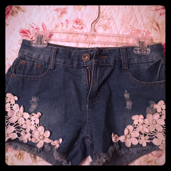Dark wash destroyed shorts with lace detail