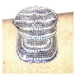 A bejeweled hat with adjustable sizing.