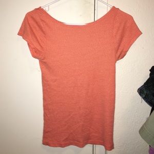 An orange scoop neck top