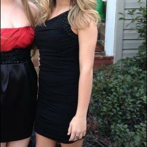 Black one shoulder dress.