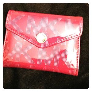 Fuchsia mini Michael Kors wallet.