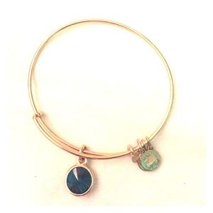 Gold Alex and Ani bracket with emerald charm