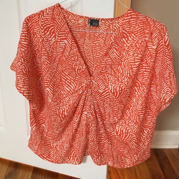 Orange and cream patterned blouse