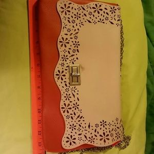 Orange and beige clutch purse.