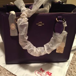NWT, never used, purple leather Coach purse.