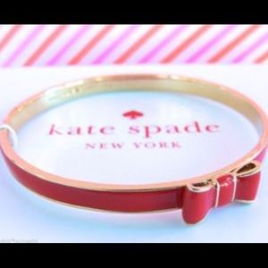 Glossy red Kate spade bangle bracelet with bow.