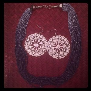 Purple necklace and large white earrings!