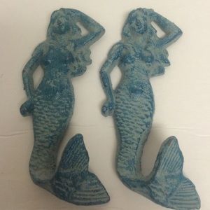 Two cast iron wall hanging mermaids,