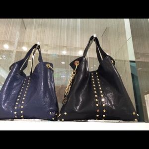 Micheal Kors Gold studded and all black leather