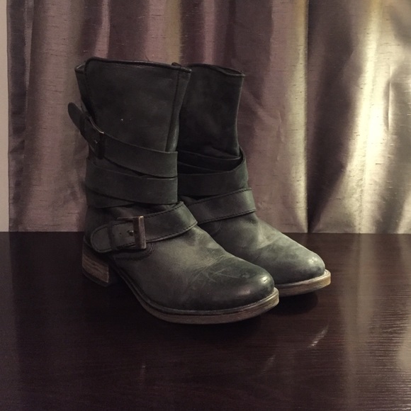 Combat/biker boots with strap details.
