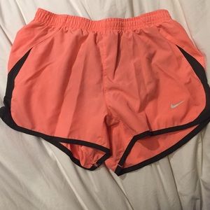 Orange Nike running shorts