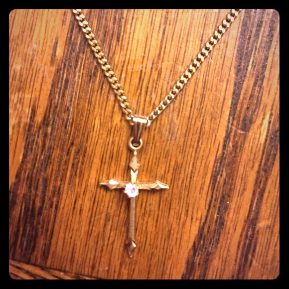 Gold cross necklace with a single diamond