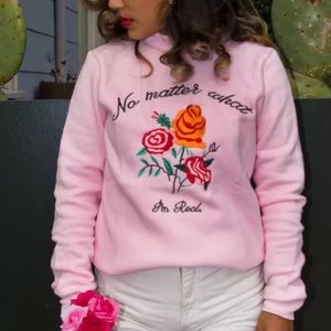"No Matter What I'm Real" pink turtleneck