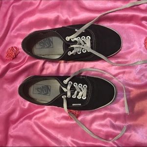 Black vans with white laces