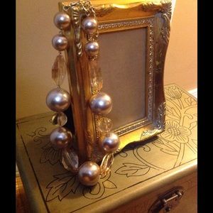 Nude  pearl necklace.