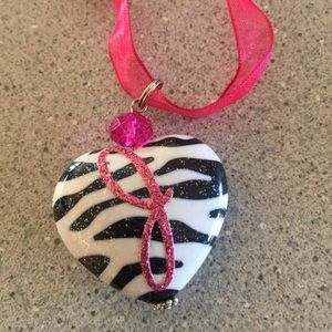 Heart zebra print pendant w/ "J" on the front.