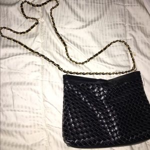 Black purse with gold leather braided chain