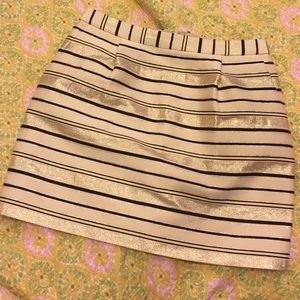 Off bone black and golden lines. Gently used