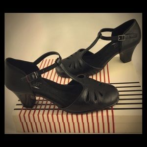 1920s style black leather T-strap heels.
