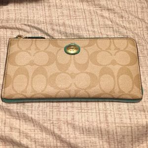 Signature Coach wallet with teal accents