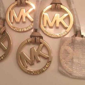 Authentic Michael kors charm golden tan