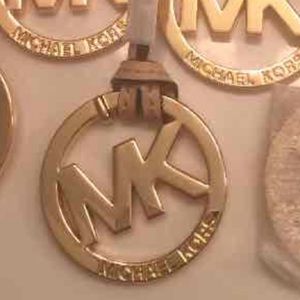 Authentic Michael kors charm golden tan