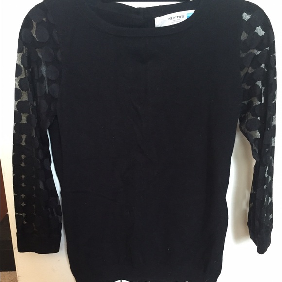 Black Anthropologie sweater with polka dot sleeve