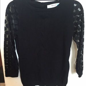 Black Anthropologie sweater with polka dot sleeve