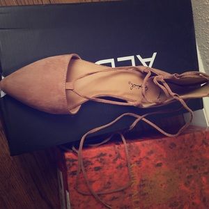 Lace up flats in tan color.