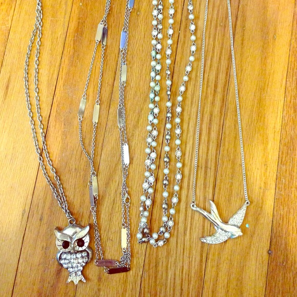 Set of four silver necklaces.